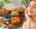 Healthy skin with a variety of dry fruits including almonds, walnuts, pistachios, cashews, dried apricots, cranberries, and blueberries rich in skin-nourishing nutrients.